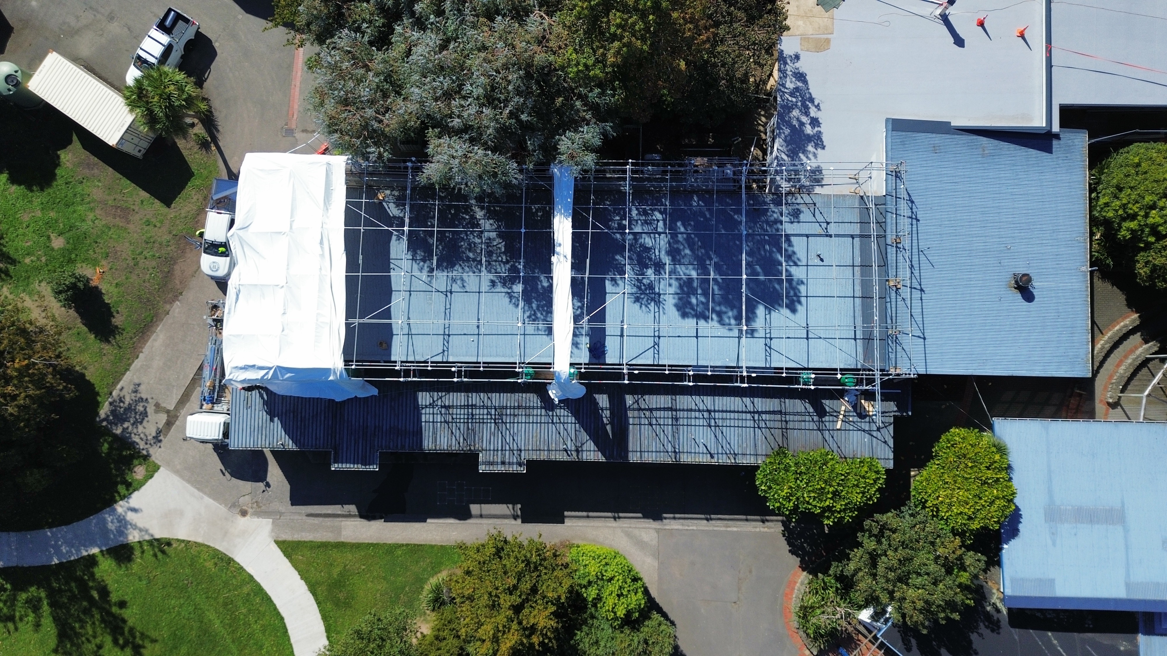Scaffold frame and shrinkwrap during installation at Avalon Primary School, Lower Hutt — scaffold structure visible before full encapsulation