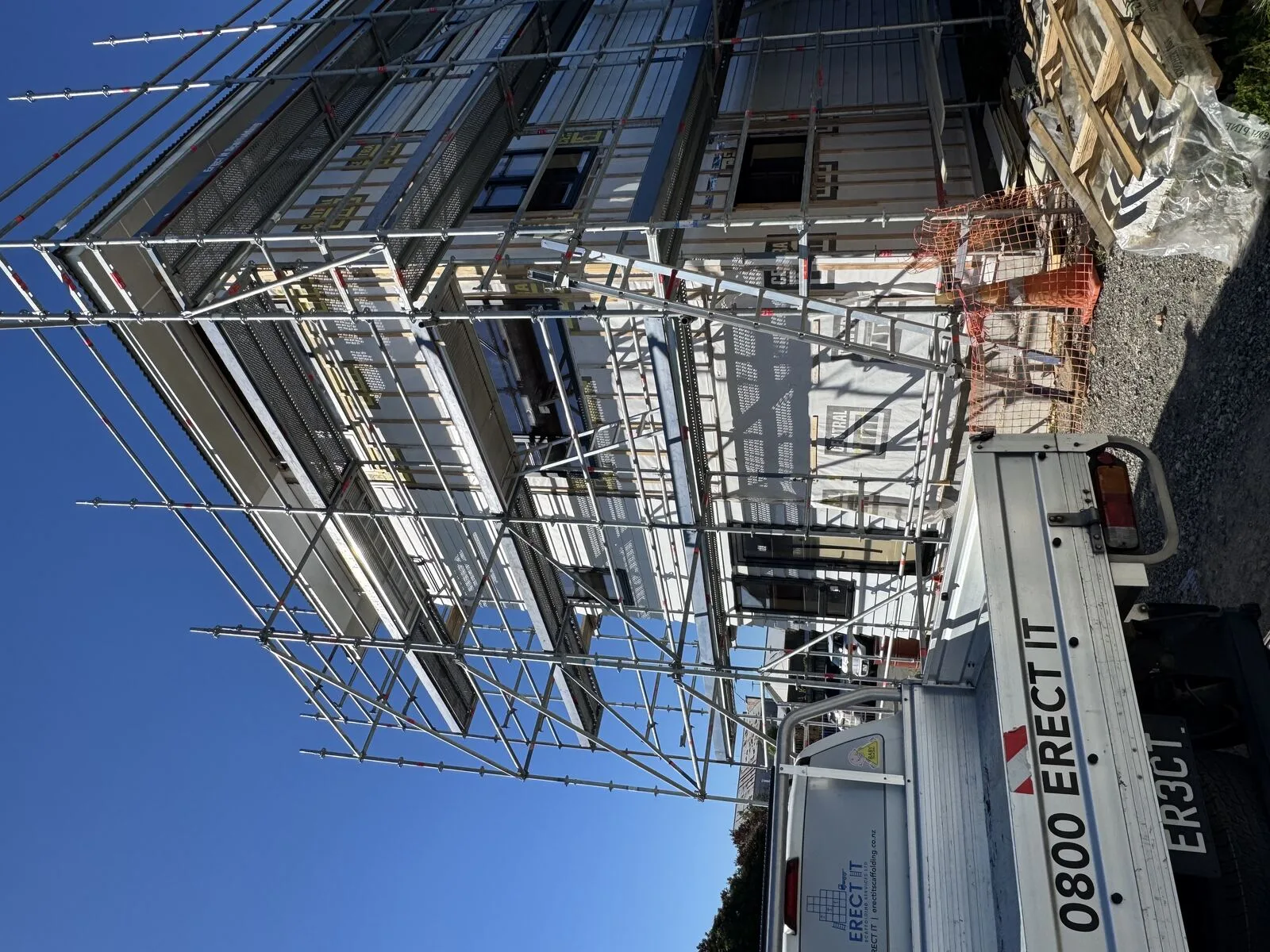 Erect It Scaffolding truck on site at a new multi-storey residential development in Carterton, Wairarapa — safe working platforms and edge protection across every level
