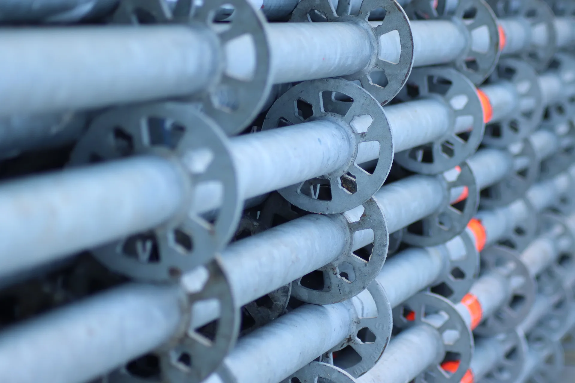 Rows of Layher ringlock standards — thousands of components ready to deploy