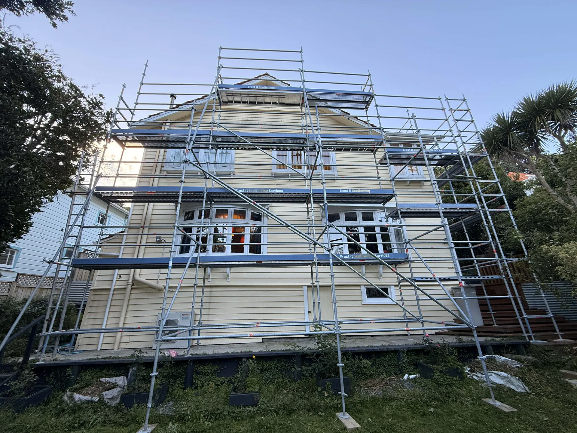 Erect It Scaffolding erected on a multi-level Hataitai Wellington home — full perimeter access across all elevations for exterior repaint and roof repairs