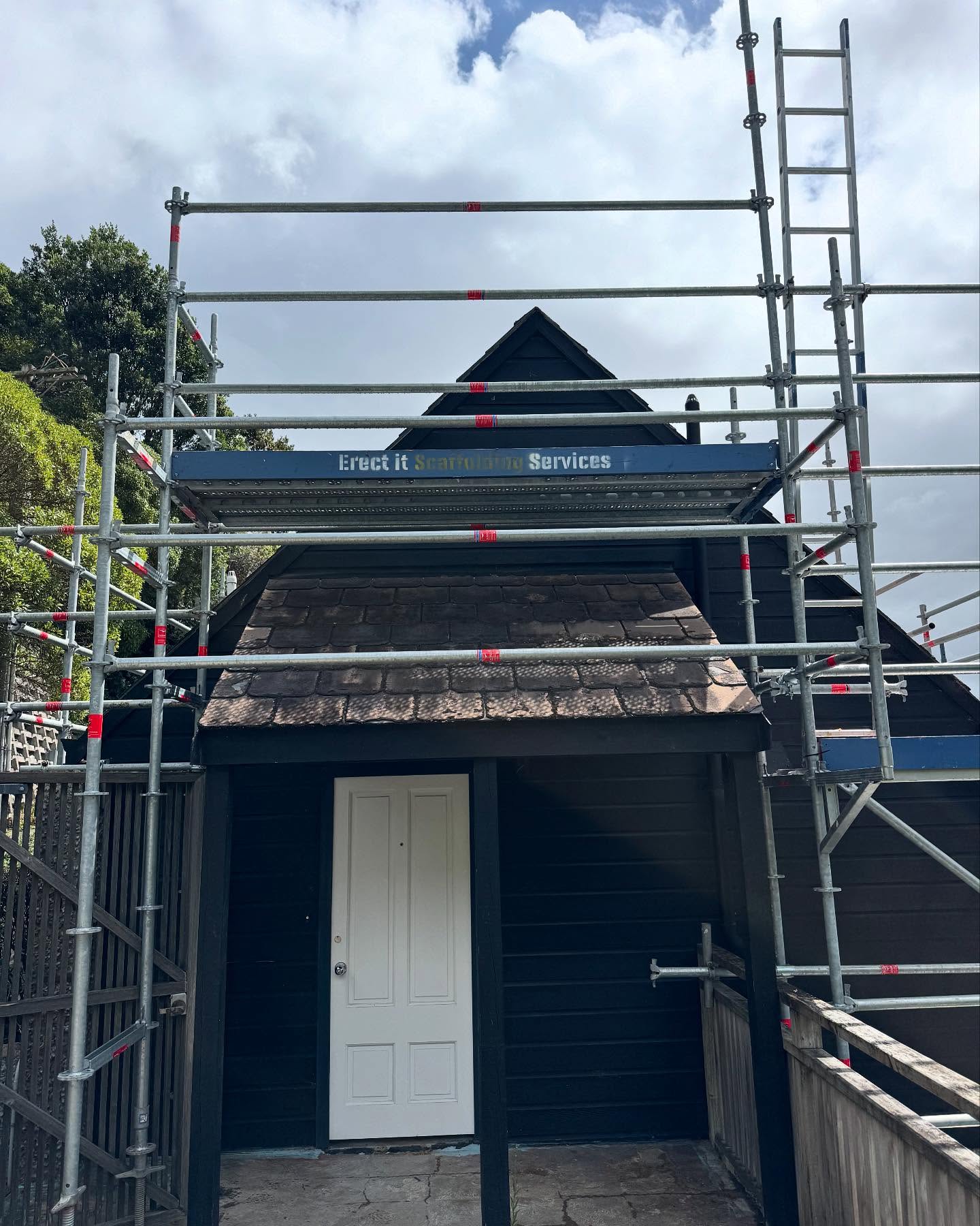 Close-up of the Erect It Scaffolding structure wrapped around the detailed Victorian gable of the Mt Victoria property — tight access, multi-level platforms, WorkSafe NZ compliant