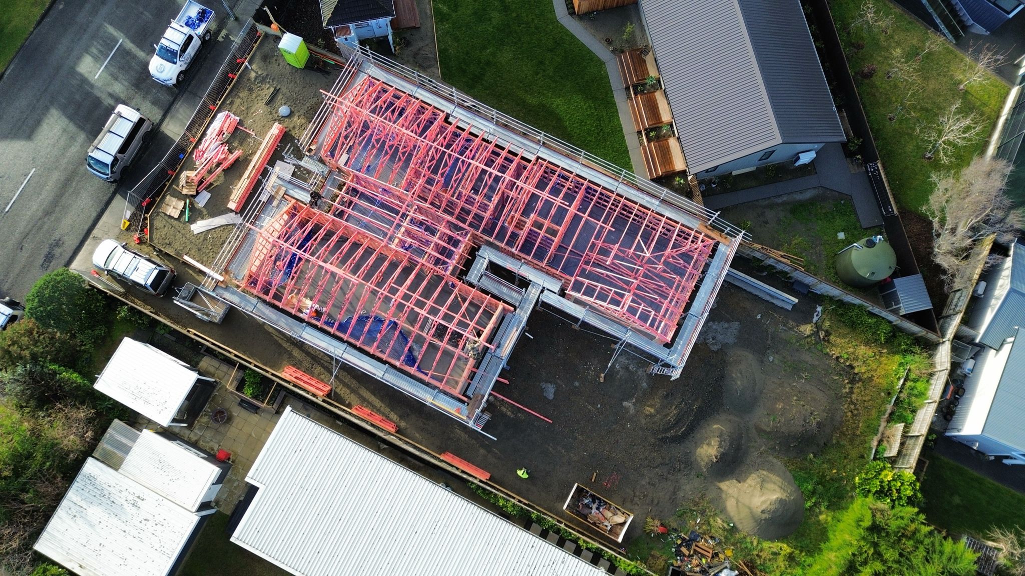 Aerial view of full-perimeter scaffolding around the timber frame of a new residential build at Ōtaki Beach