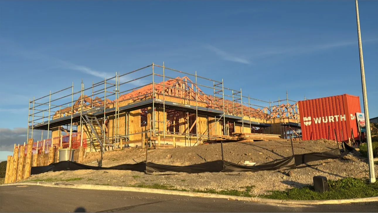 Erect It Scaffolding on a new residential showhome build in Plimmerton's newest subdivision, Porirua — full perimeter scaffolding with guardrails supporting framers and cladders