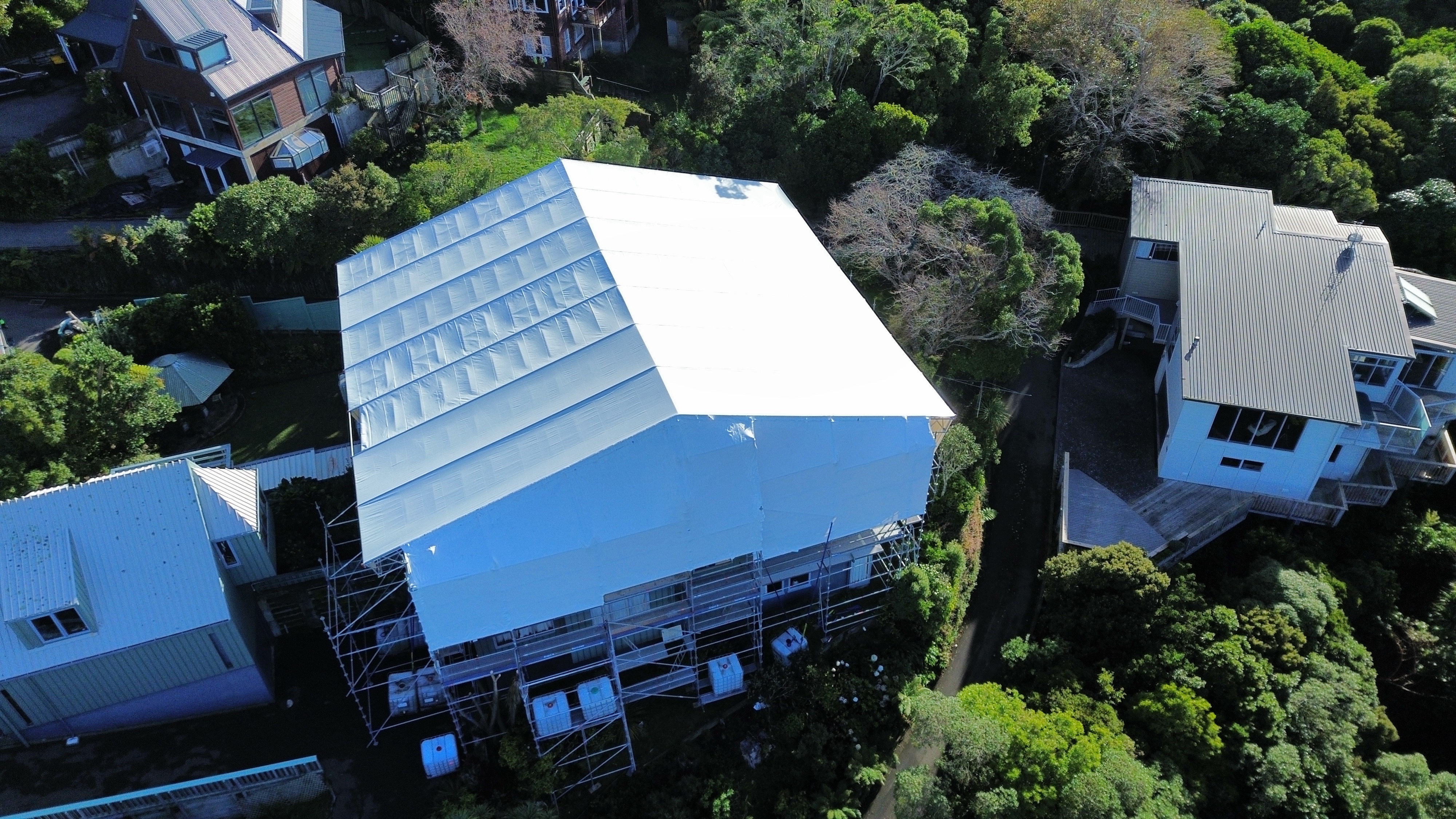 Scaffolding shrinkwrap encapsulation on a residential property in Lower Hutt — aerial view — Erect It Scaffolding