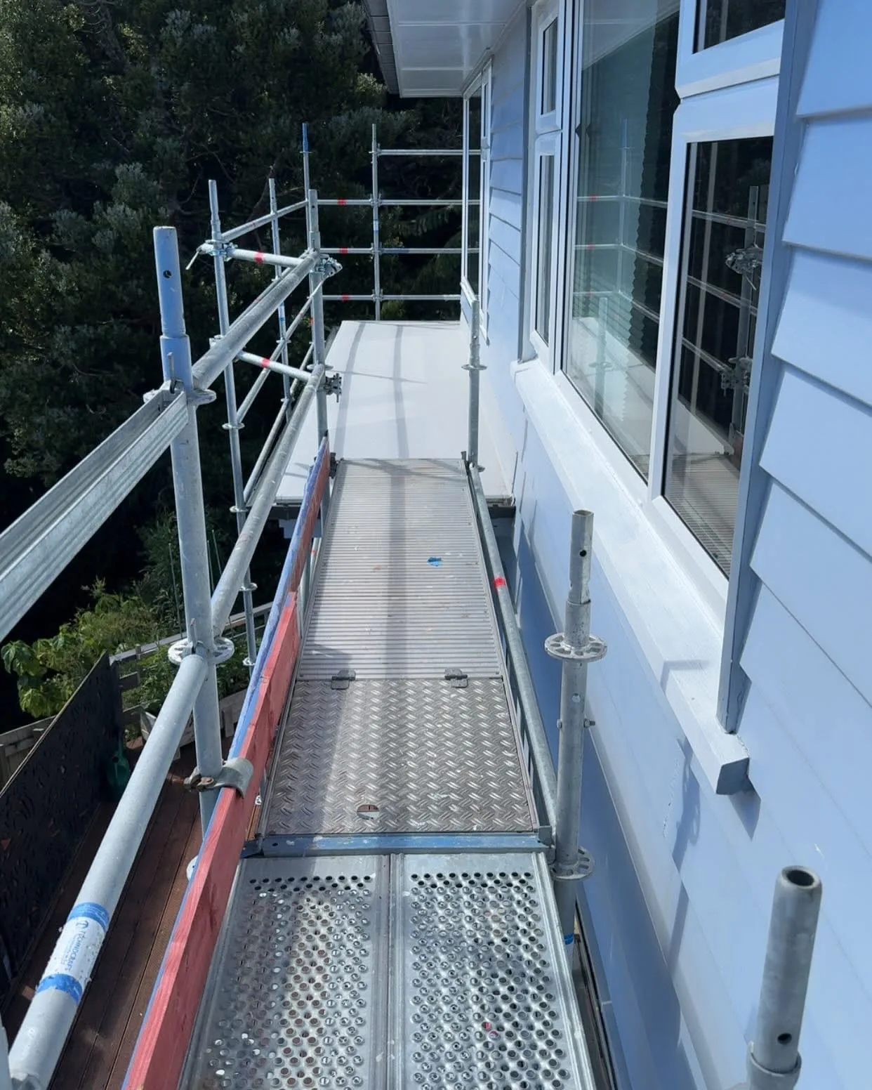 Close view of the scaffold deck beside the Waiwhetū home's windows and weatherboards