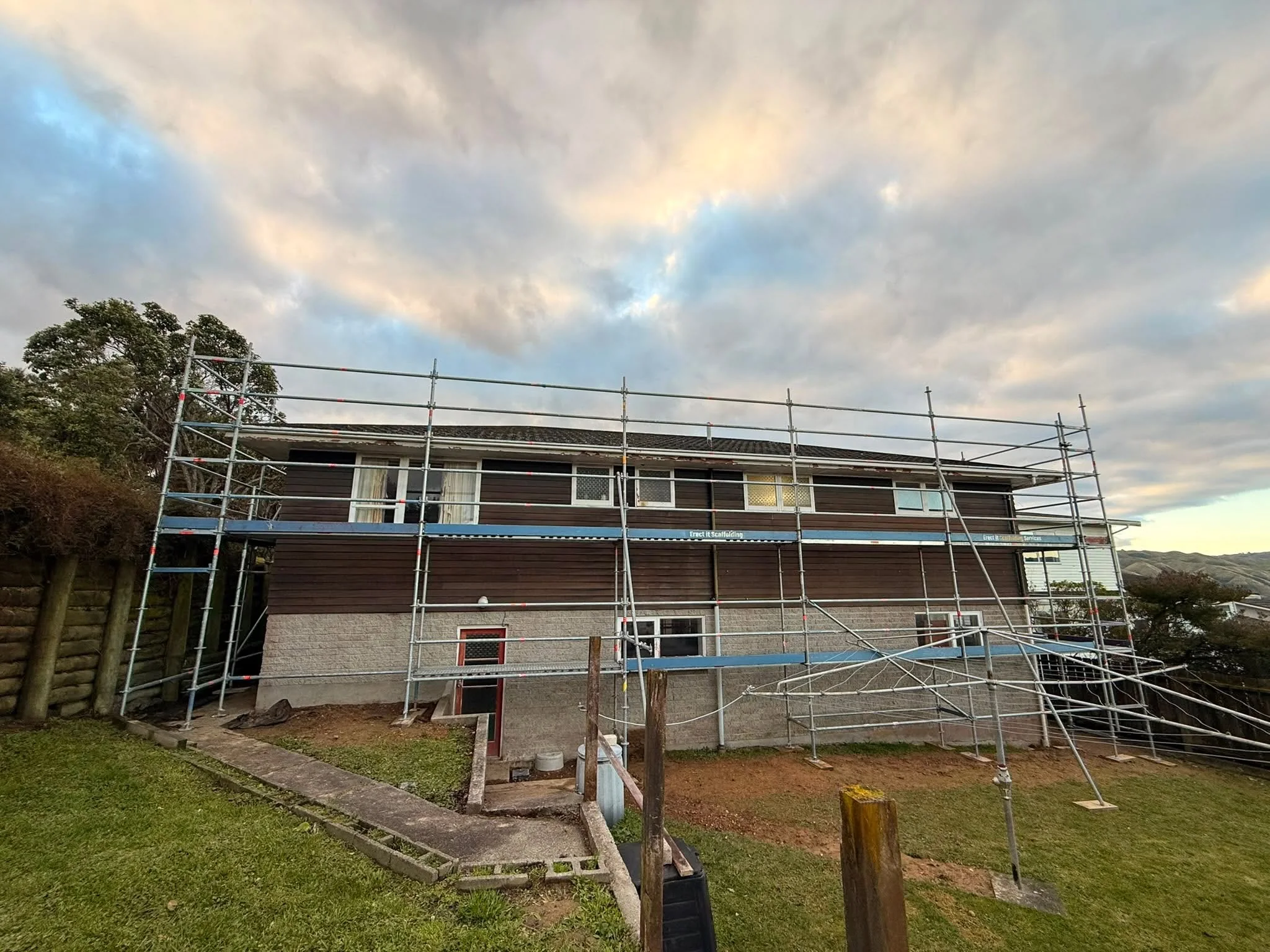 Full residential scaffolding around a two-storey Whitby home for reroofing, recladding, and window installation